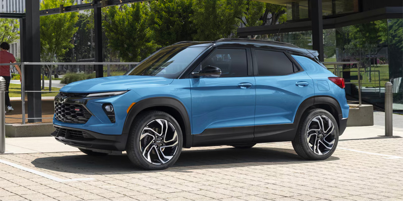 2026 Chevrolet Trailblazer compact SUV in blue parked outside a modern building.